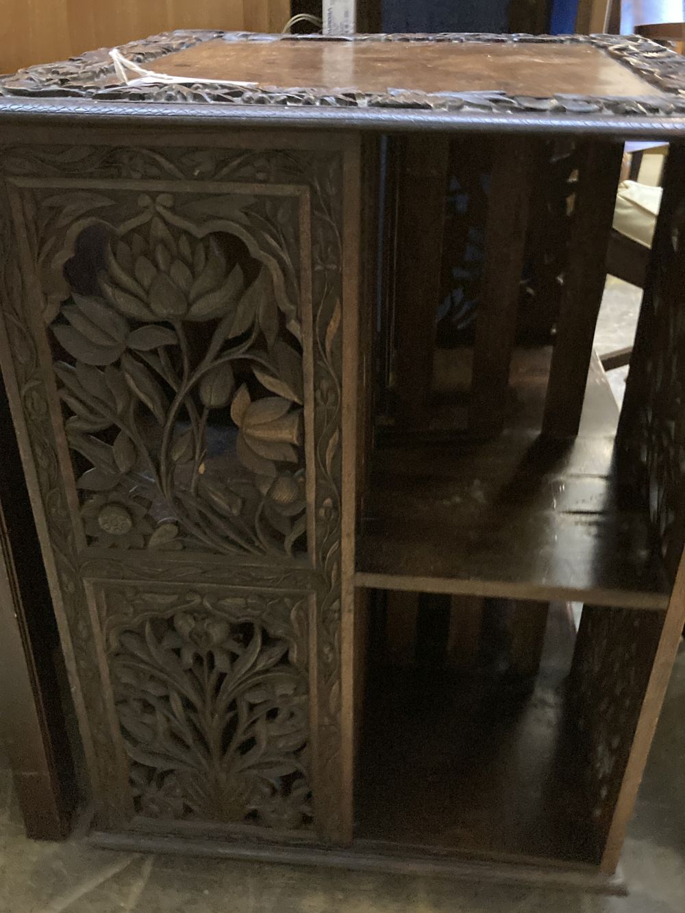 An Indian carved hardwood revolving bookcase, width 53cm, depth 53cm, height 75cm